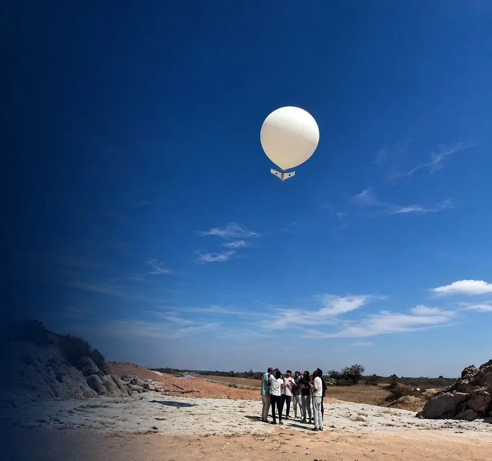 The launch team on open ground as the balloon carries the aircraft upward